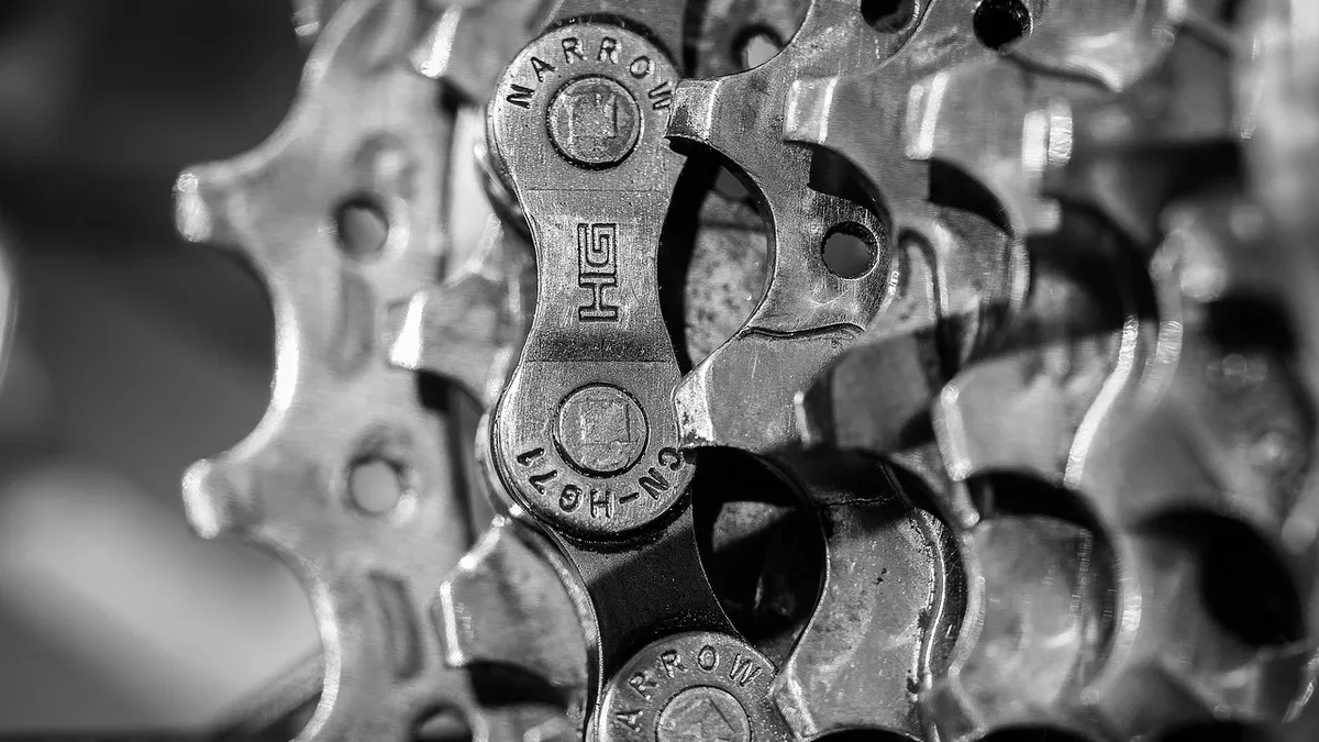 A close-up view of a bicycle gear system, featuring a chain and sprockets.